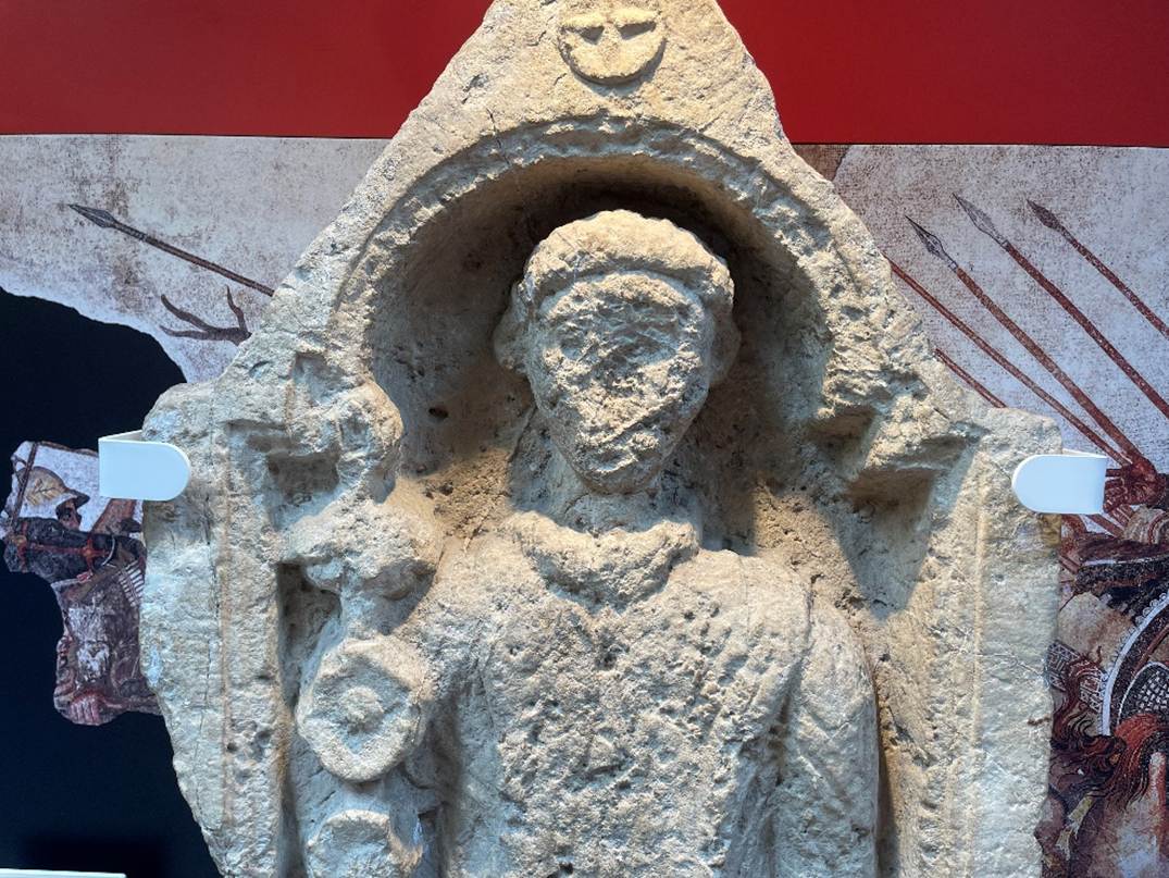 A stone statue of a person
Description automatically generated