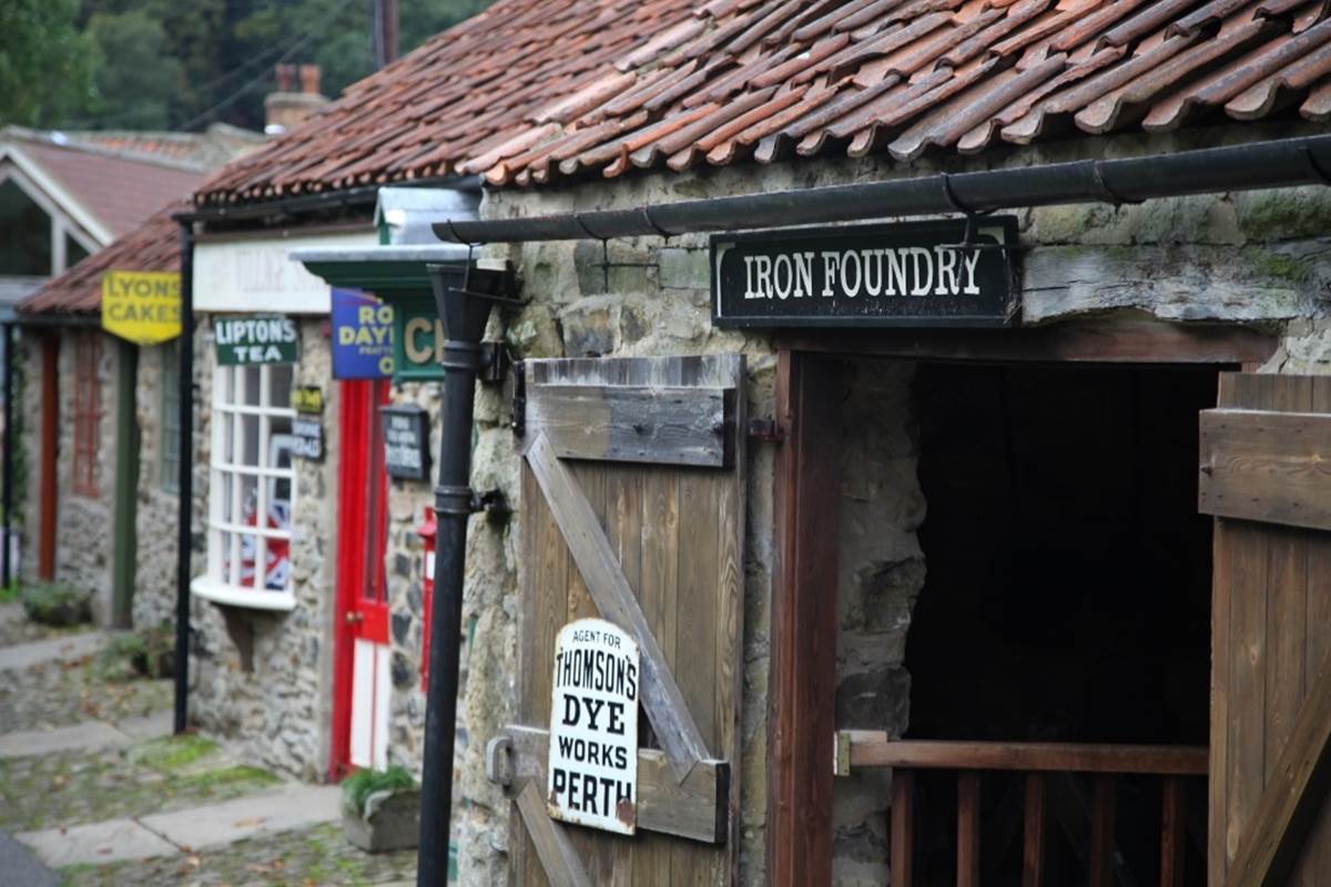 A stone building with a door open
Description automatically generated