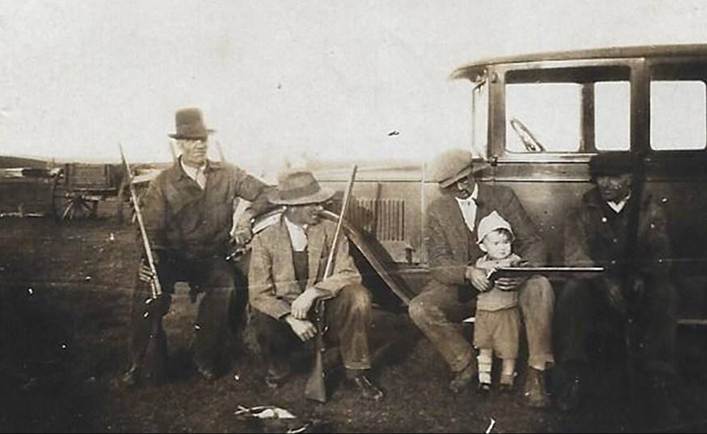 A picture containing old, black, group, posing

Description automatically generated