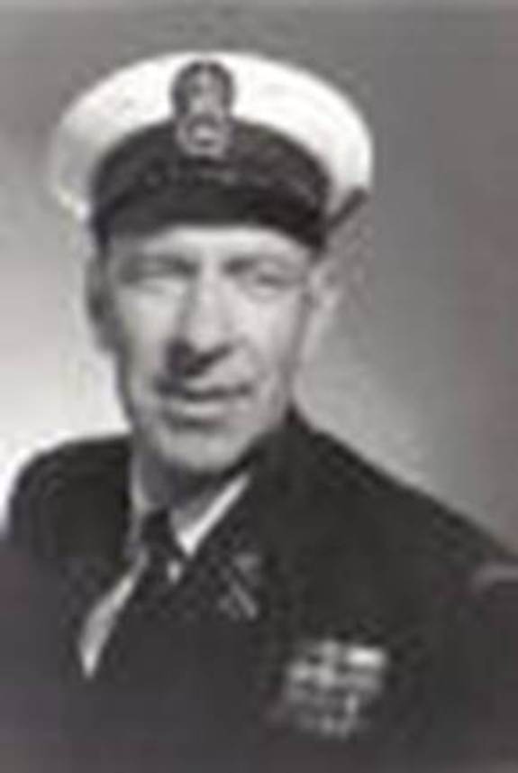 A person in a uniform and hat
Description automatically generated