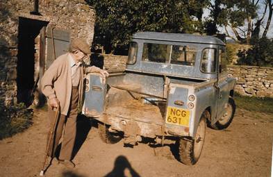 A person looking at a dirty truck
Description automatically generated