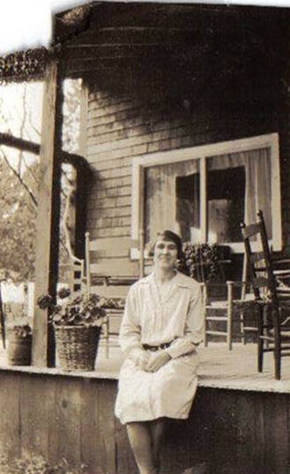 A person sitting on a porch
Description automatically generated