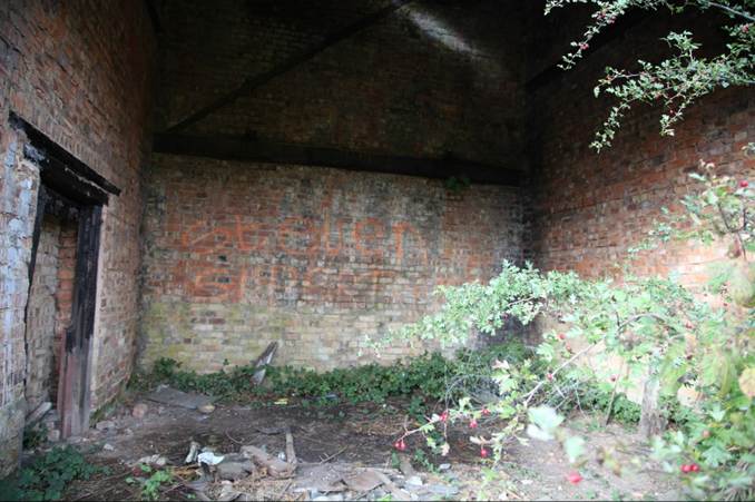 A brick wall with graffiti on it

Description automatically generated