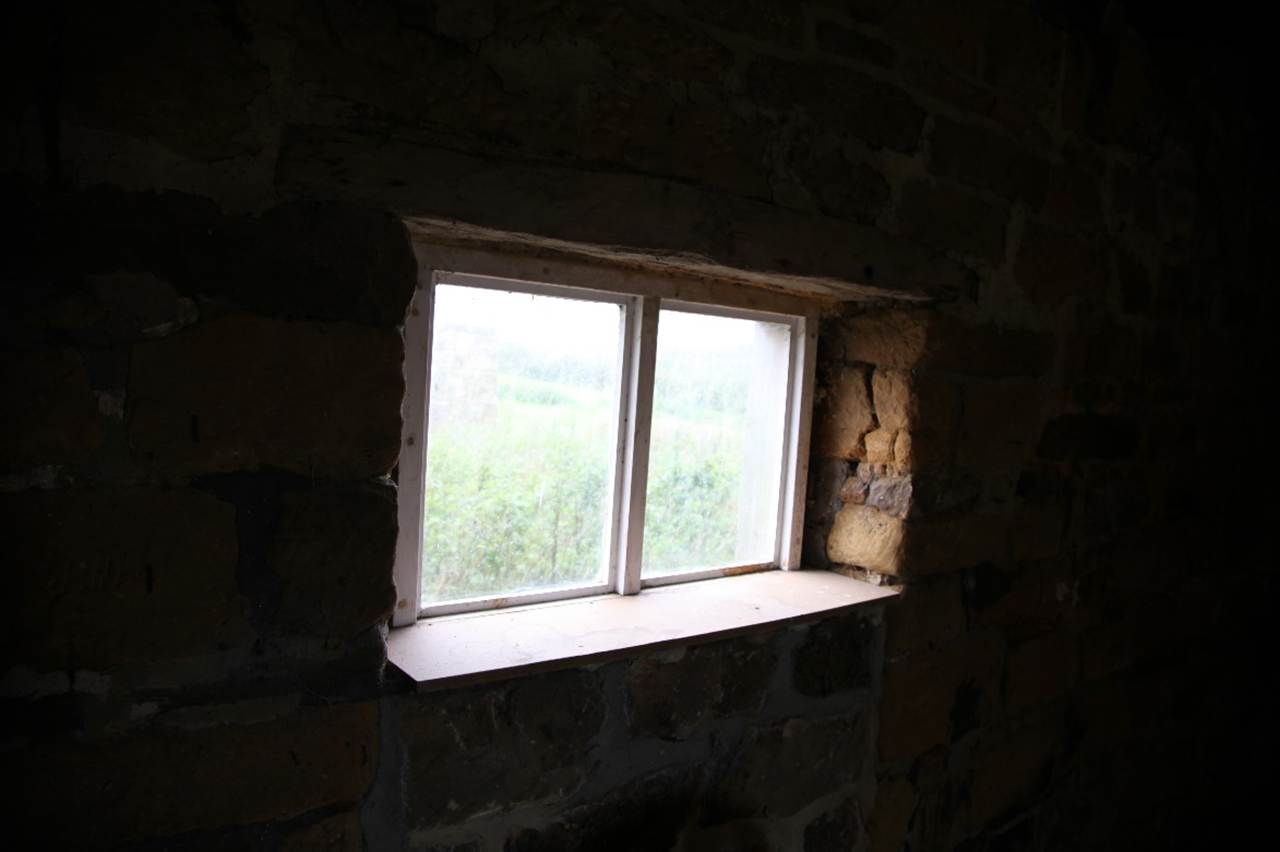 A window in a stone wall
Description automatically generated