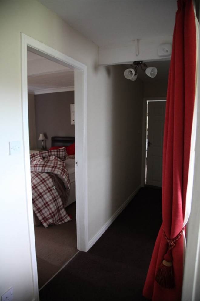 A view from the doorway of a bedroom
Description automatically generated
