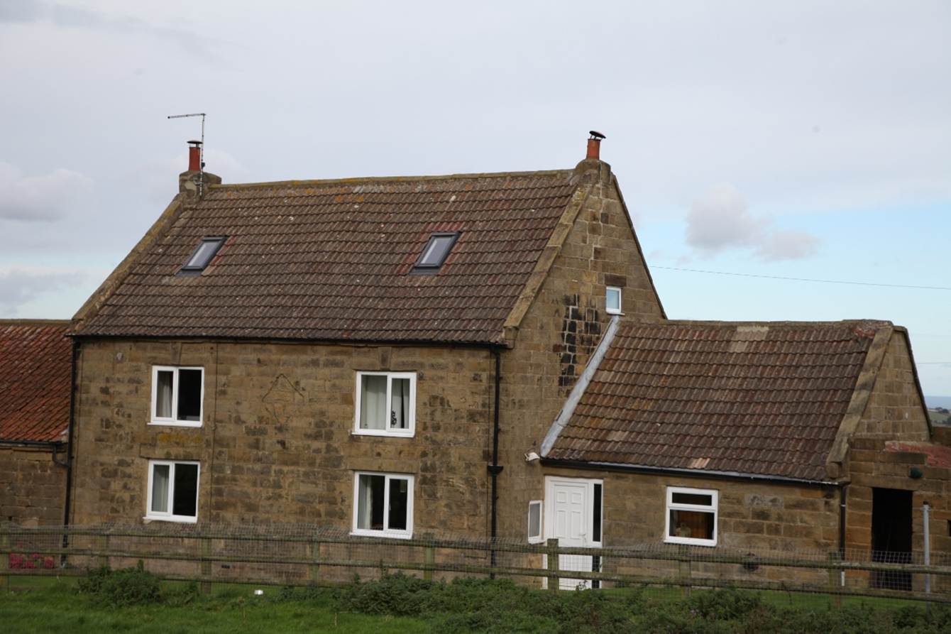 A house with a fence
Description automatically generated