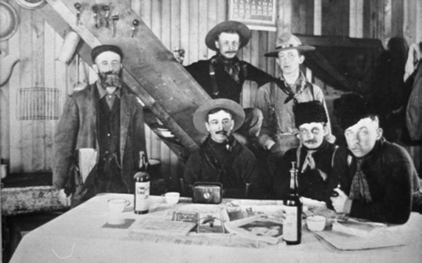 A group of men in cowboy clothing
Description automatically generated