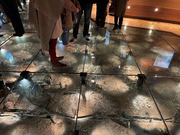 A group of people standing on a floor

Description automatically generated