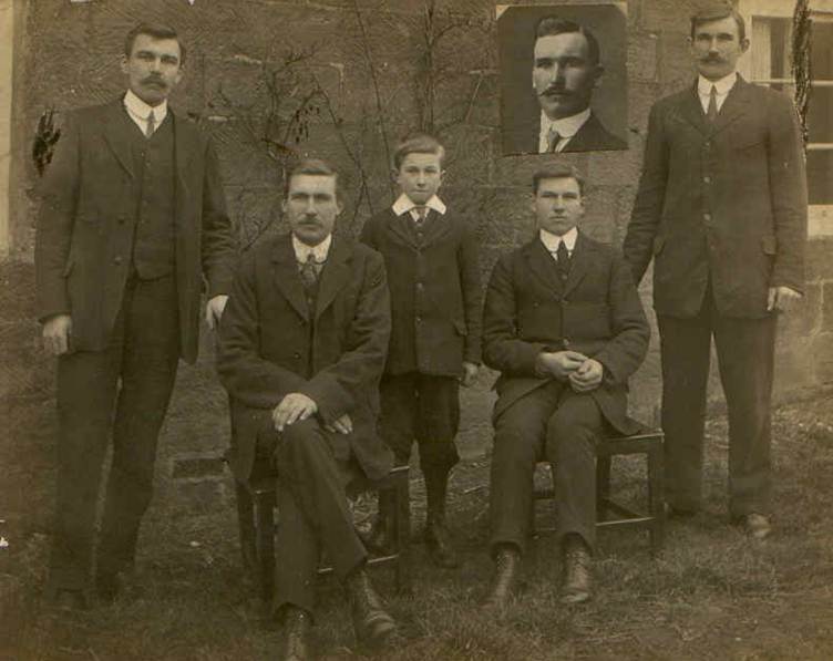 A group of men in suits
            Description automatically generated